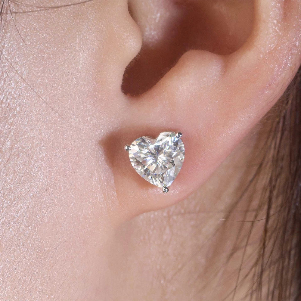 Woman wearing a heart cut moissanite stud earring in white gold, close up on the earlobe - Sensitive Stones