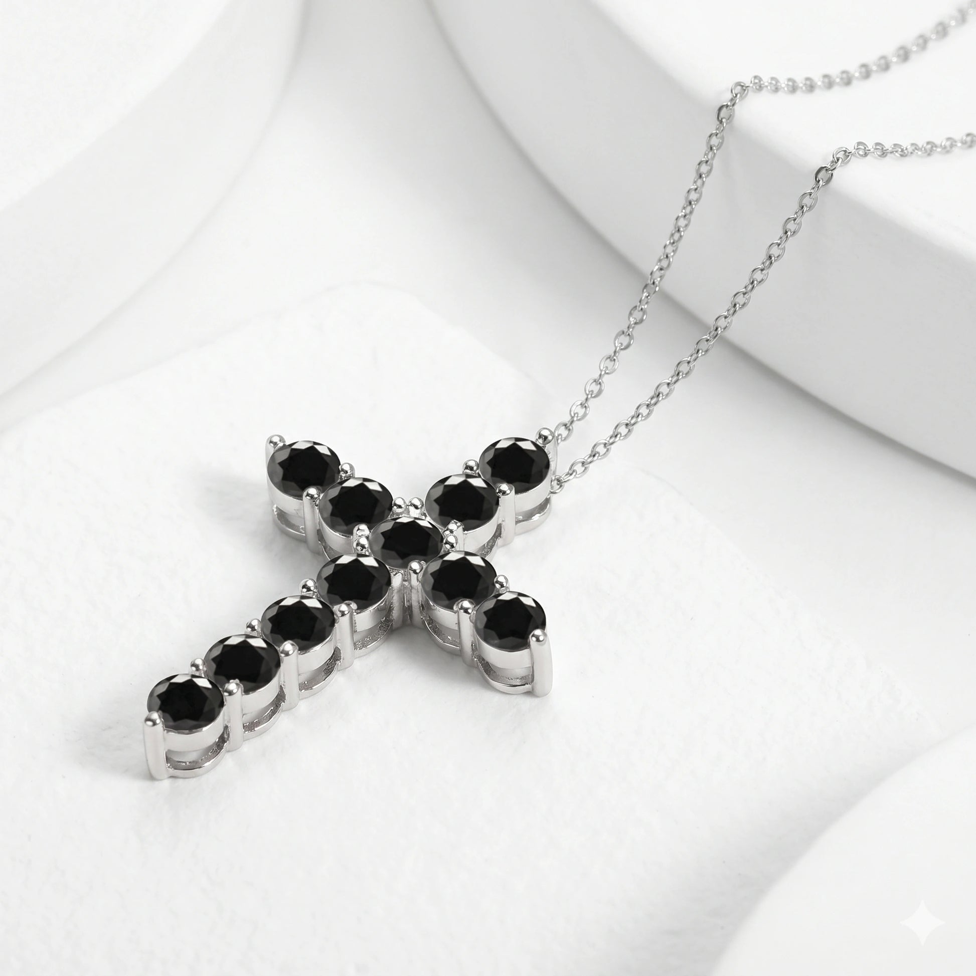 Black moissanite cross pendant necklace in 925 sterling silver displayed on white jewelry box, prong setting with 11 stones - Sensitive Stones