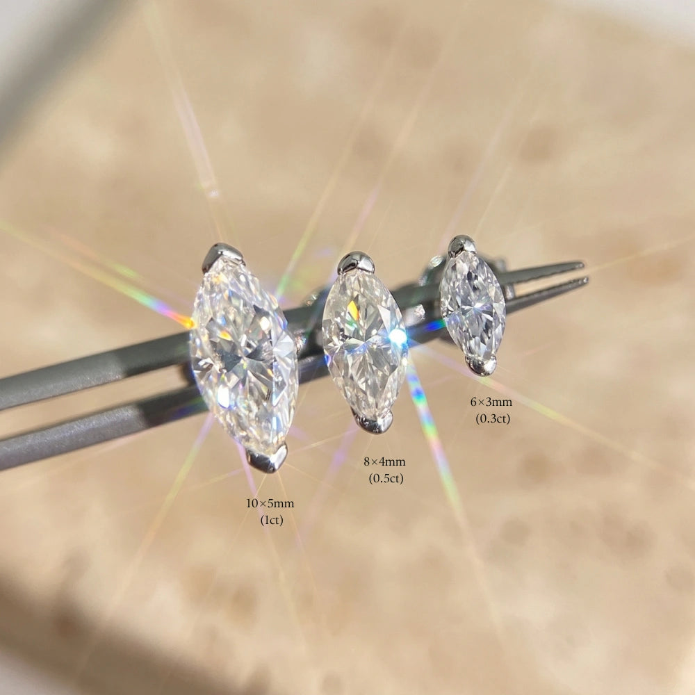 Marquise cut moissanite stud size comparison in white gold, 10x5mm 1ct next to 8x4mm 0.5ct and 6x3mm 0.3ct