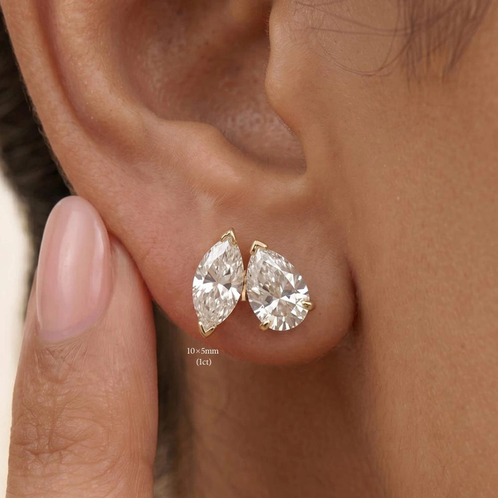 10x5mm yellow gold marquise cut moissanite stud worn next to a pear cut stud in the same ear