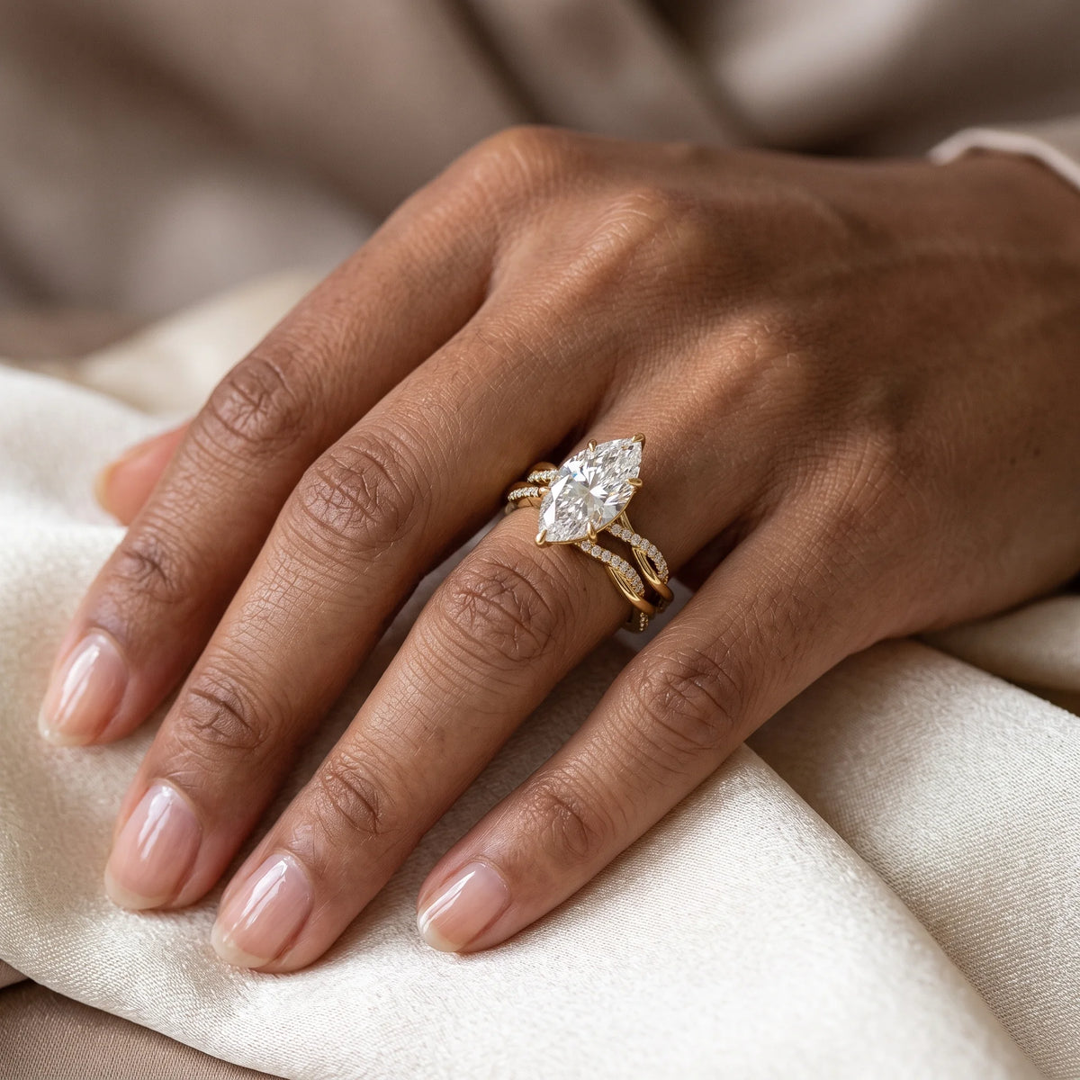 Marquise moissanite bridal set in 14K gold filled worn on the hand, the marquise engagement ring stacked with its matching twisted band - Sensitive Stones