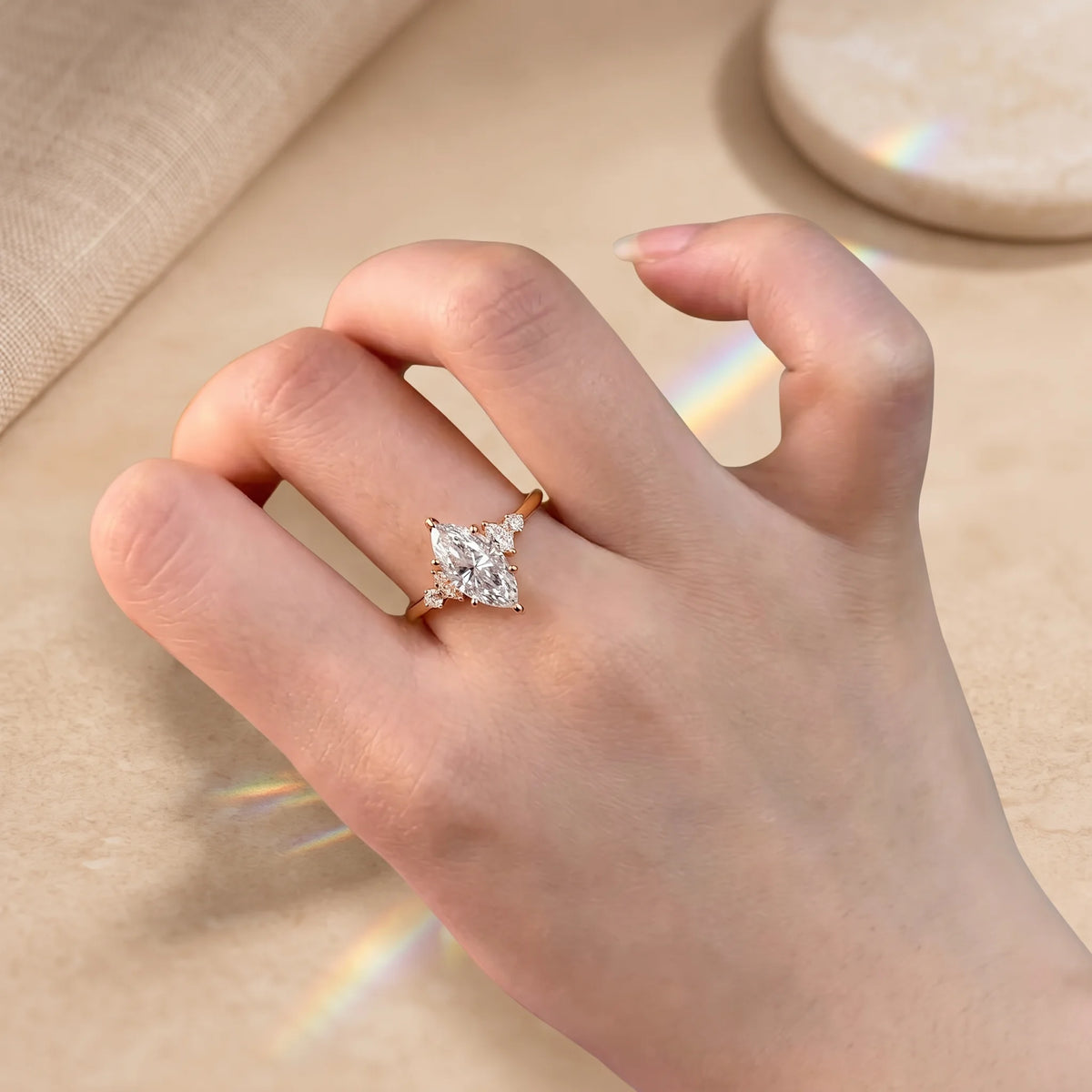 Woman wearing a 2ct marquise moissanite engagement ring in 14K gold filled on her ring finger