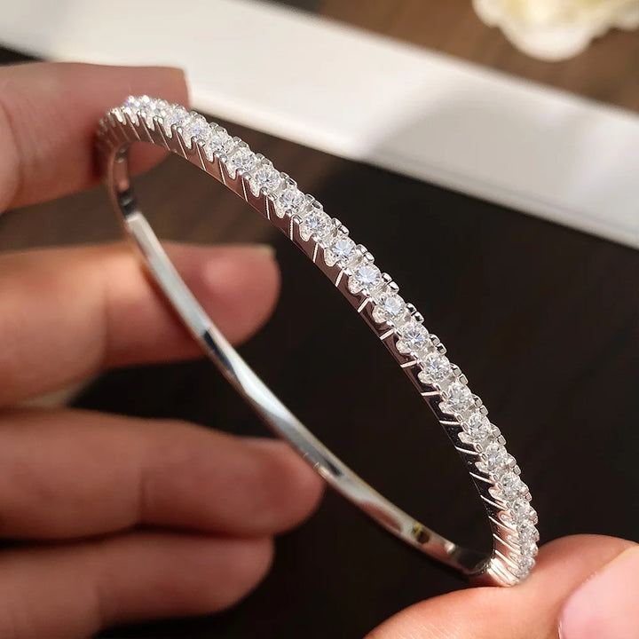 Close-up of moissanite bangle bracelet, 925 sterling silver, hand-held view – Sensitive Stones
