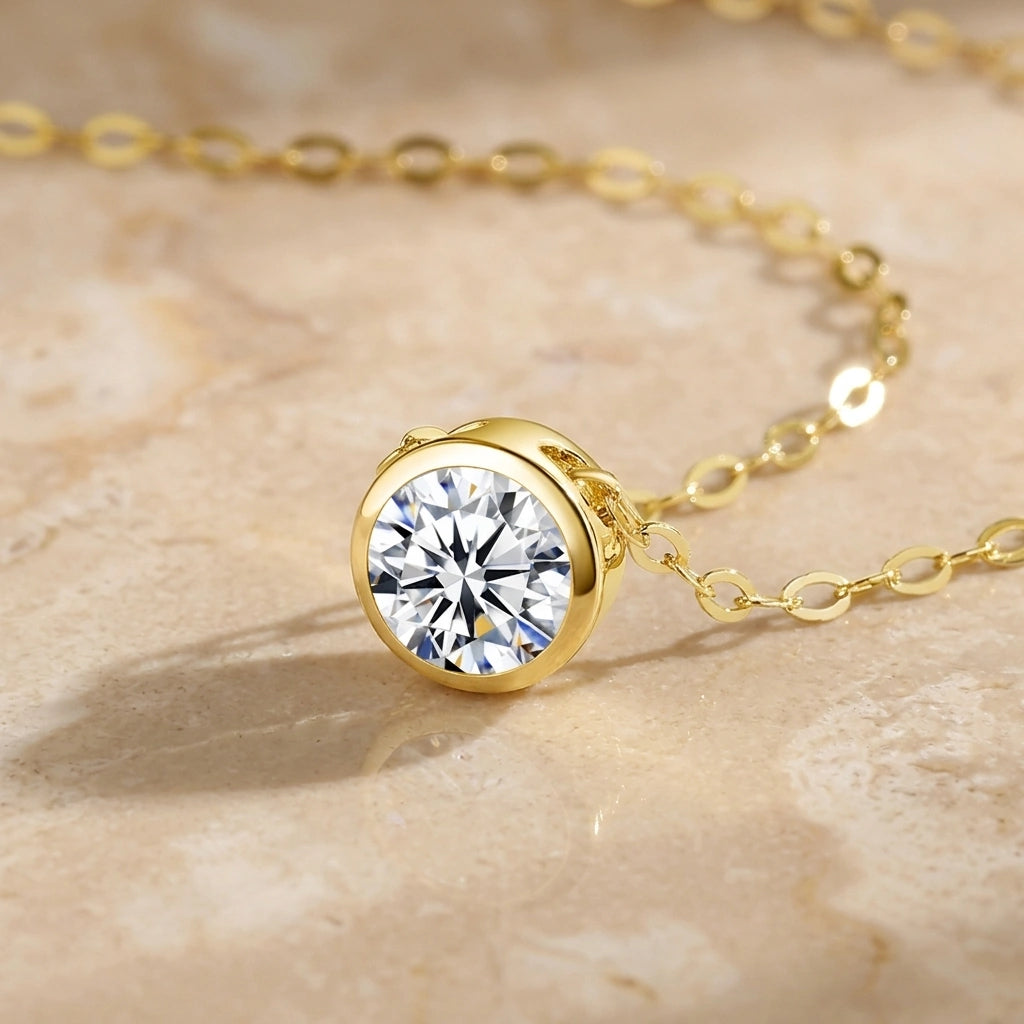 Close-up of a 6.5mm moissanite in a smooth 14K gold filled bezel with the chain threaded through - Sensitive Stones