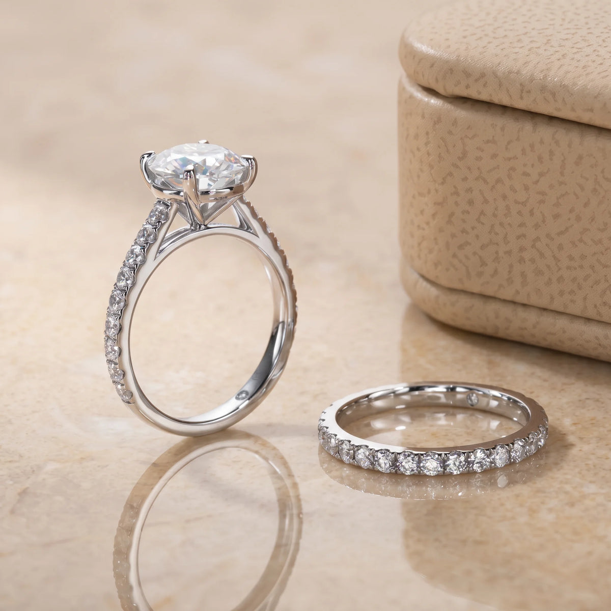 Moissanite bridal ring set profile view showing the open gallery under the 4-prong center stone beside the pave wedding band - Sensitive Stones