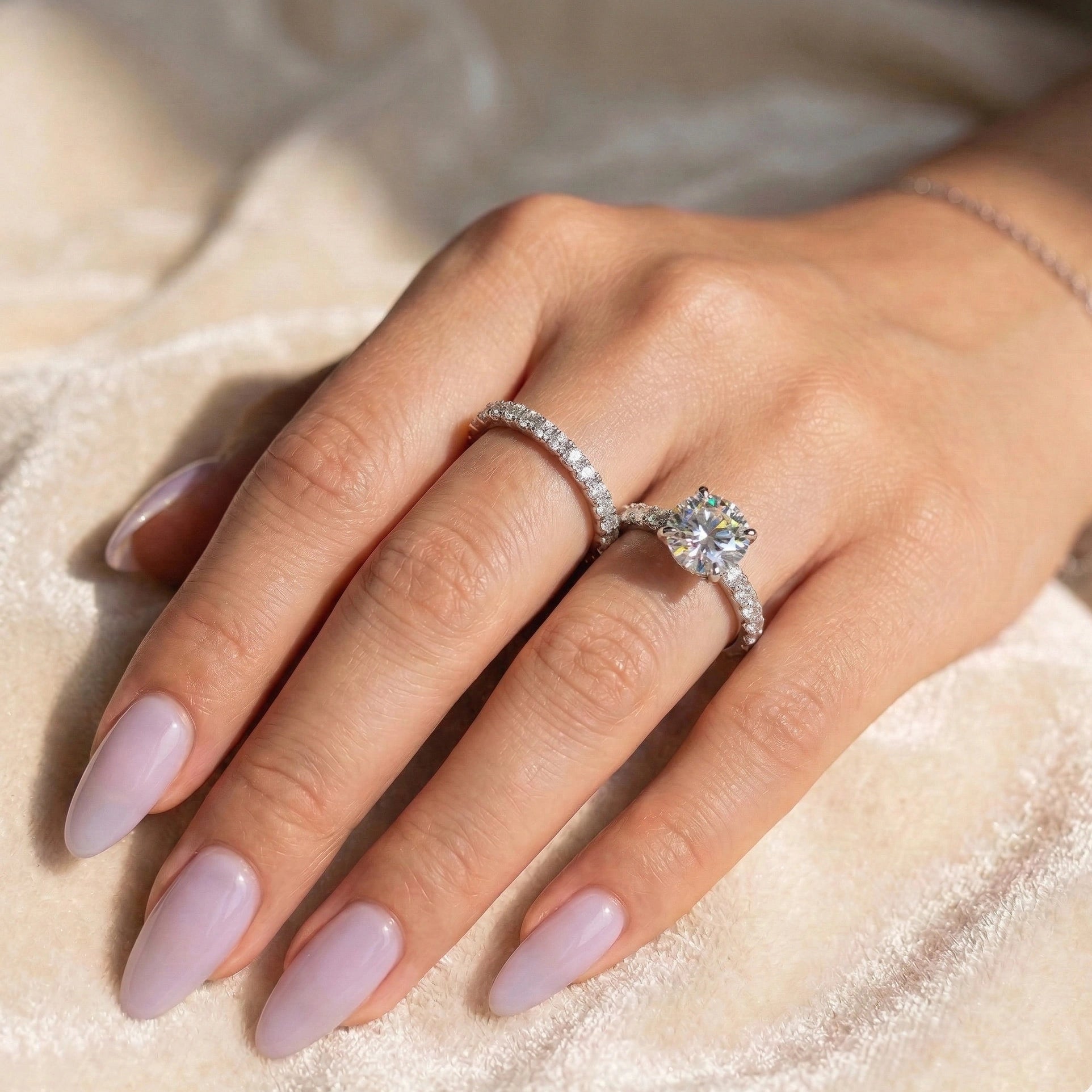 Moissanite bridal ring set worn on ring finger with matching wedding band on adjacent finger - Sensitive Stones