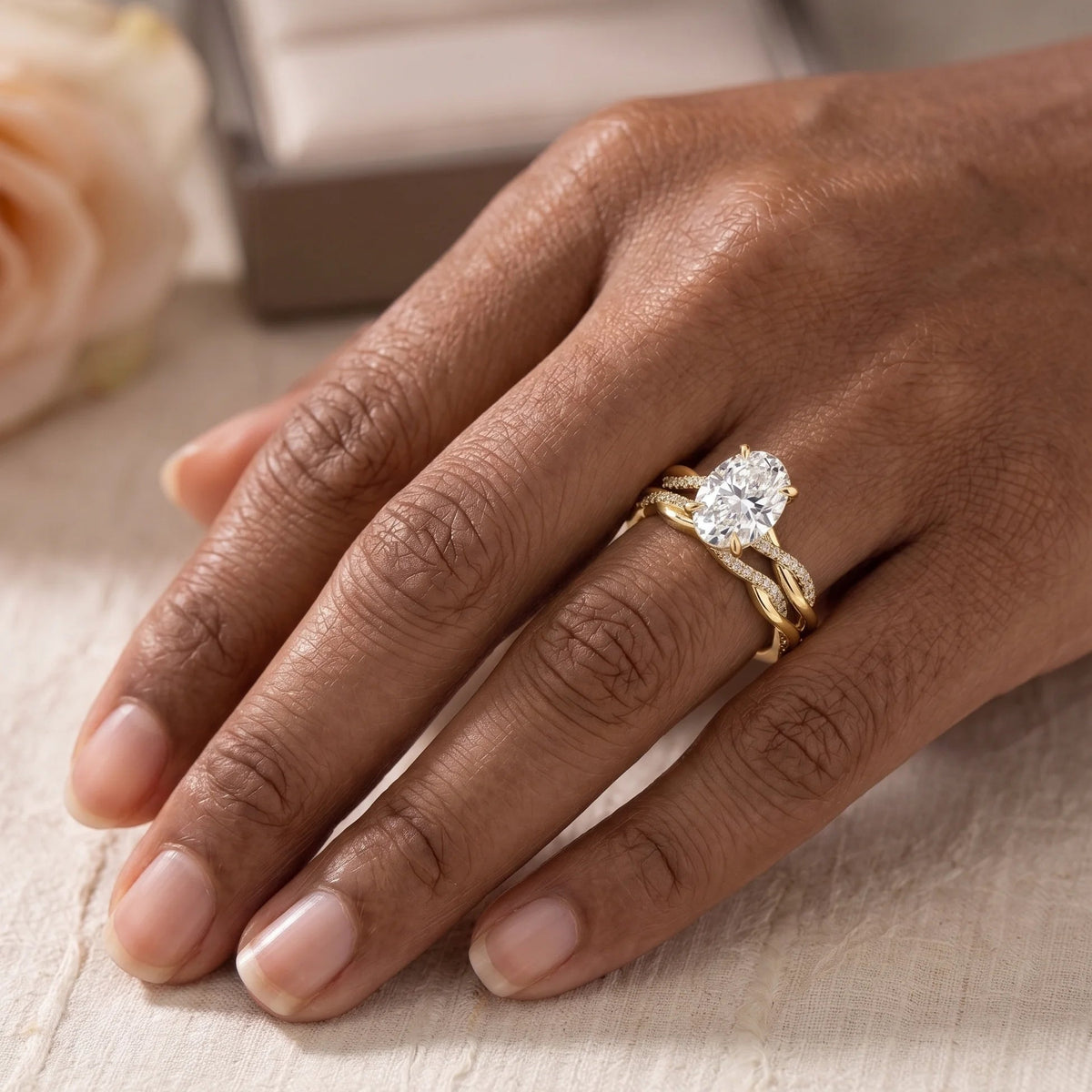 Moissanite bridal set in 14K gold filled worn on the hand, the oval engagement ring stacked with its matching twisted band - Sensitive Stones