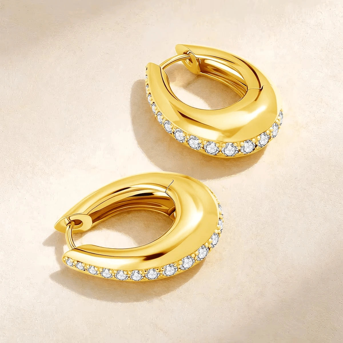 Moissanite chunky pavé hoop earrings in 18K gold plating lifestyle flat lay on textured surface showing hinge closure detail - Sensitive Stones