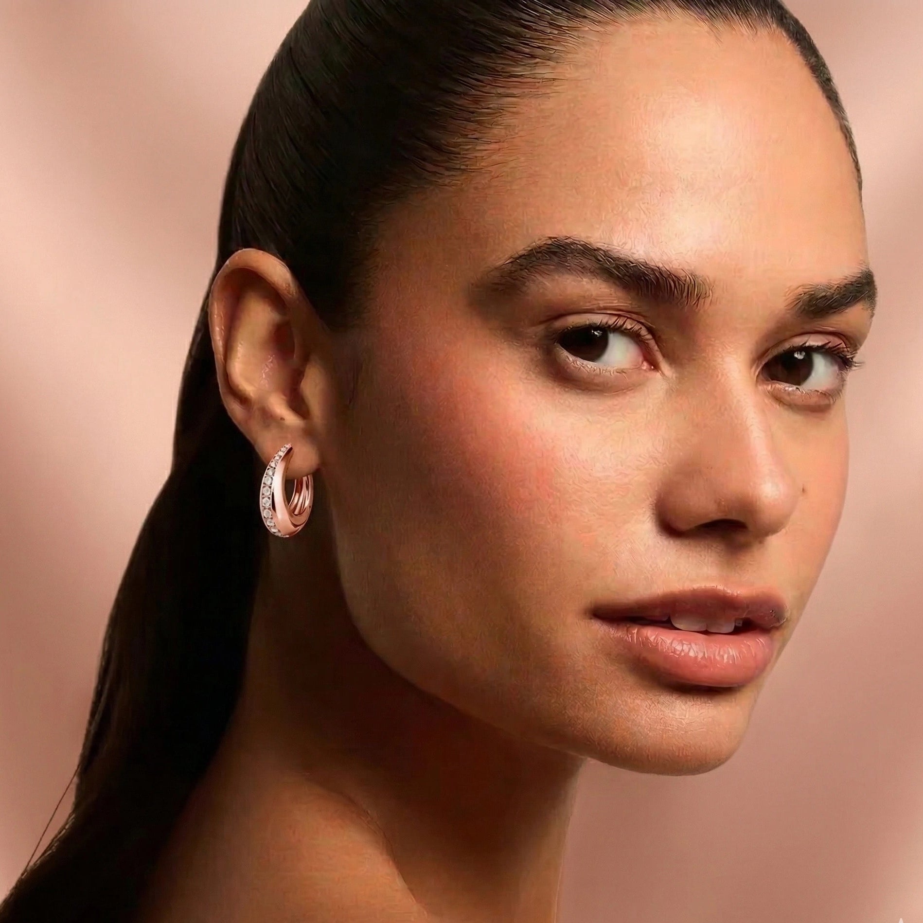 Moissanite chunky pavé hoop earrings in 18K rose gold plating worn on model portrait close-up - Sensitive Stones