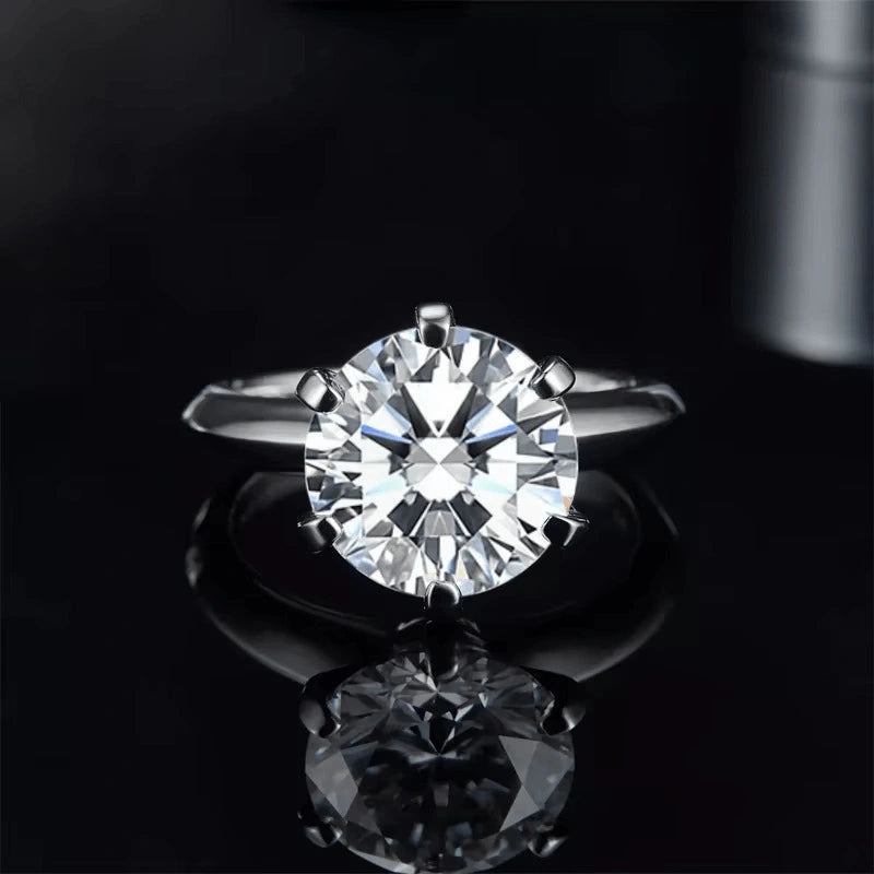 6-prong classic moissanite solitaire ring front view on black background - Sensitive Stones