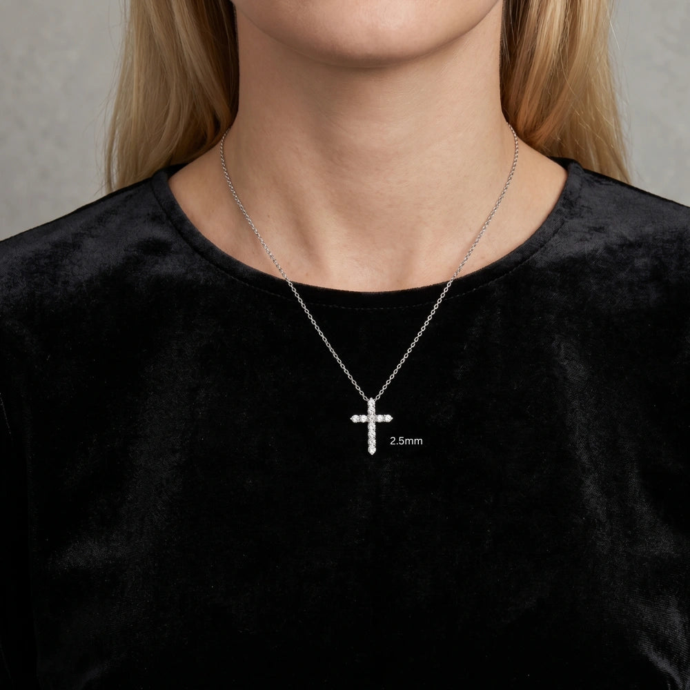 2.5mm moissanite cross pendant necklace in 925 sterling silver worn on model with black top, delicate everyday size - Sensitive Stones