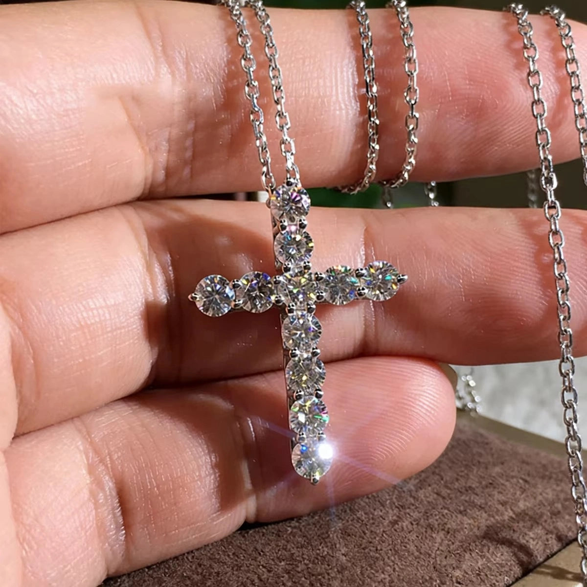 Close-up of moissanite cross pendant necklace in 925 sterling silver, showing D color VVS1 stone brilliance and fire - Sensitive Stones