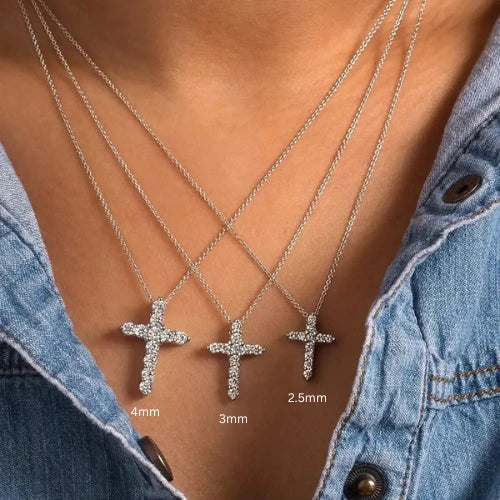 Three moissanite cross pendant necklaces with moissanite stone sizes 2.5mm, 3mm and 4mm worn over a denim top – Sensitive Stones