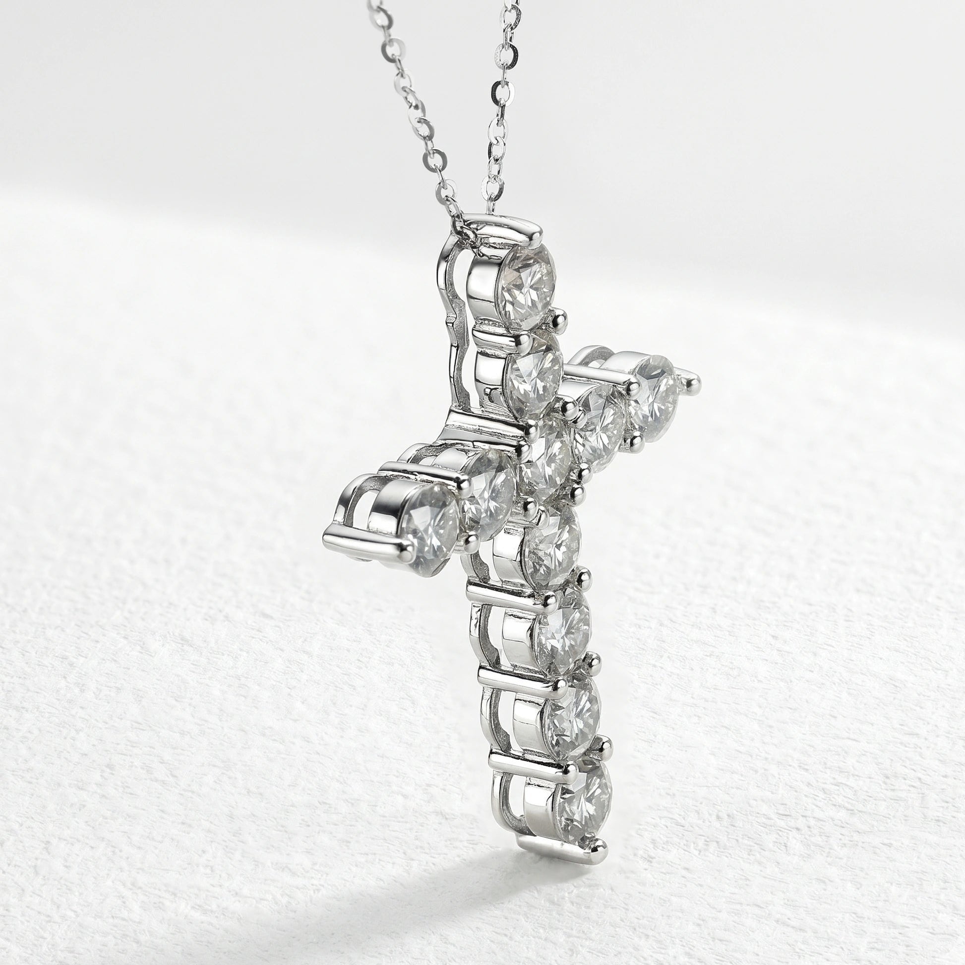 Side angle view of moissanite cross pendant necklace in 925 sterling silver showing prong setting and D color VVS1 stone clarity - Sensitive Stones