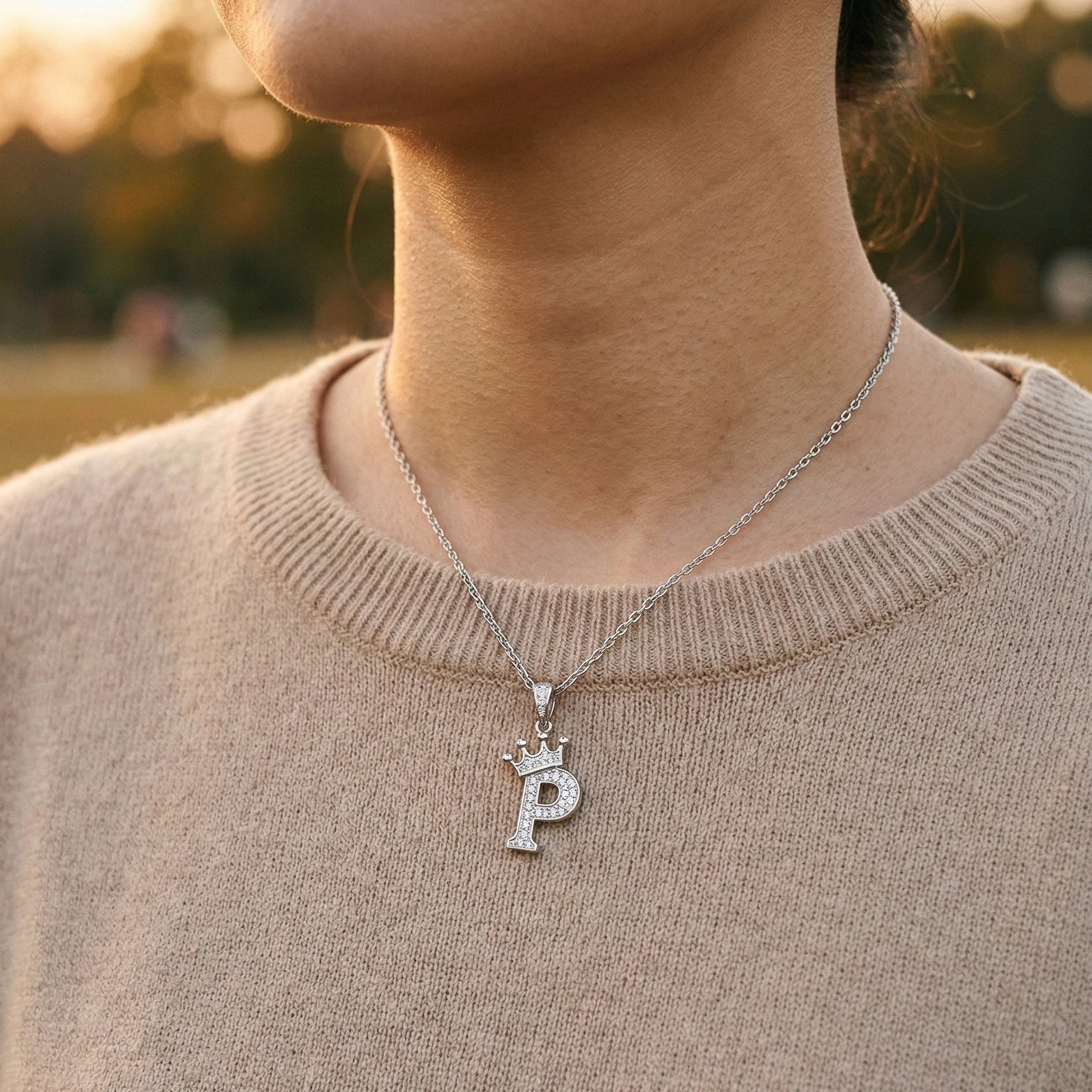 Moissanite crown initial necklace letter P worn outdoors golden hour beige knit sweater - Sensitive Stones