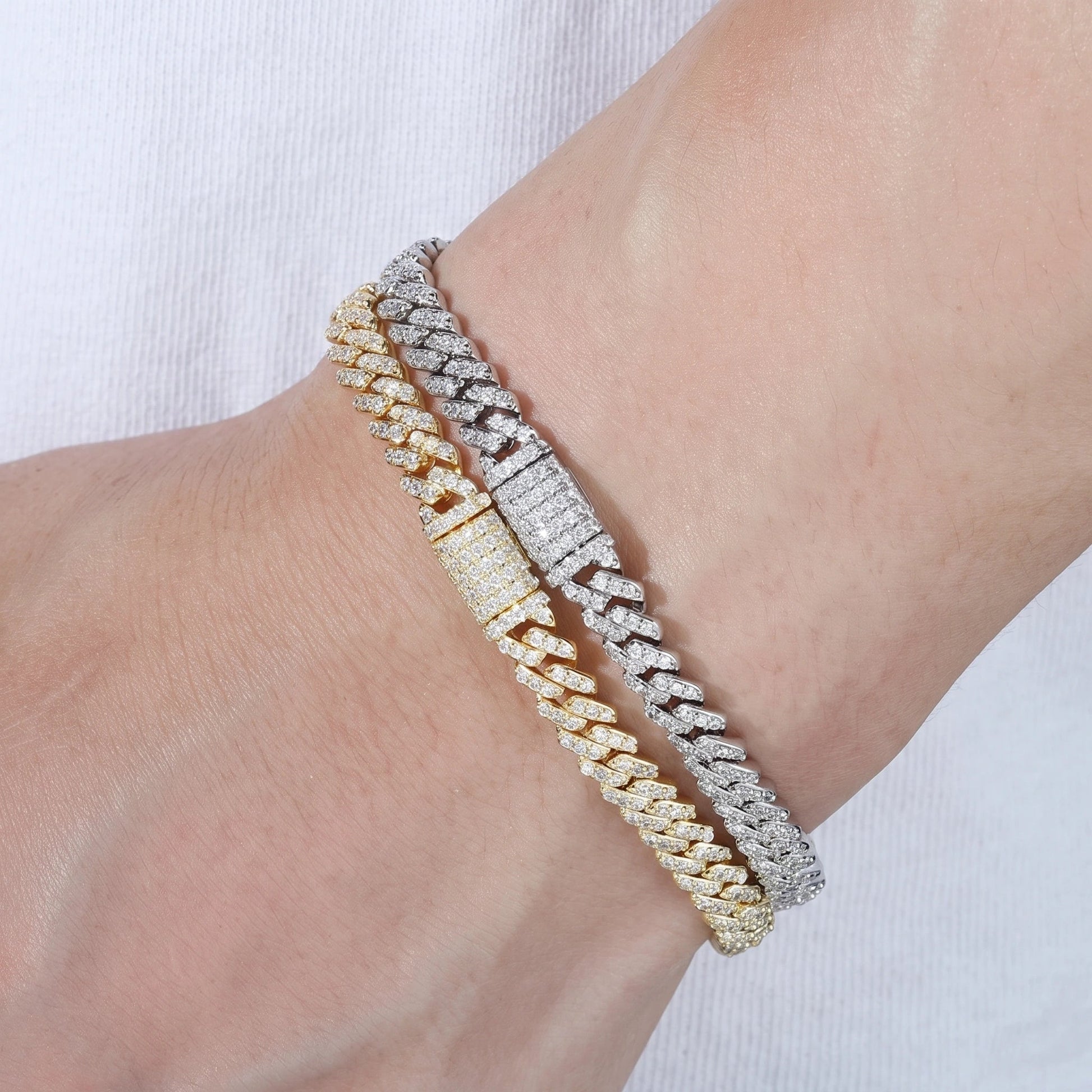 White gold and yellow gold 6mm moissanite Cuban link bracelets worn stacked on the wrist