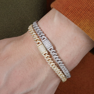 White gold and yellow gold 6mm moissanite Cuban link bracelets worn stacked on the wrist
