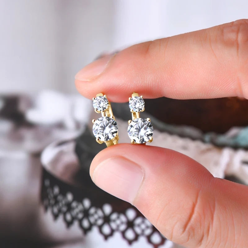 2.6ct moissanite double stone huggie hoop earrings in yellow gold plating held in hand - Sensitive Stones