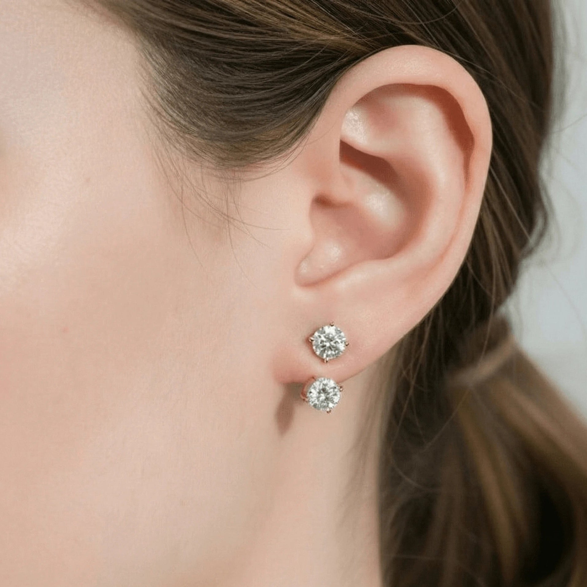 Sterling silver moissanite double stud jacket earrings in rose gold plating shown on ear, elegant side view, unique front-back look - Sensitive Stones