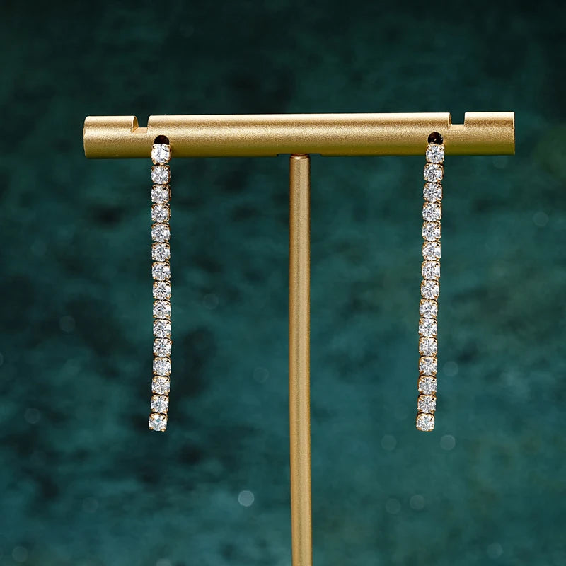 Moissanite drop dangle earrings, gold version, close-up showing 30 D color VVS1 stones in prong setting - Sensitive Stones