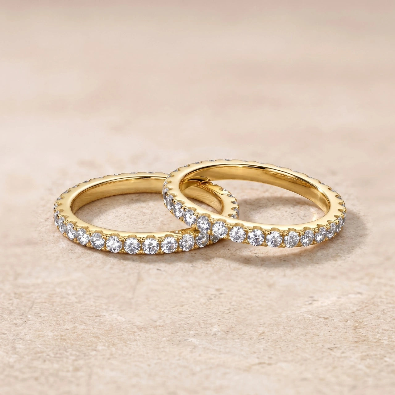 Two moissanite full eternity rings with 18k gold finish stacked on beige background - Sensitive Stones