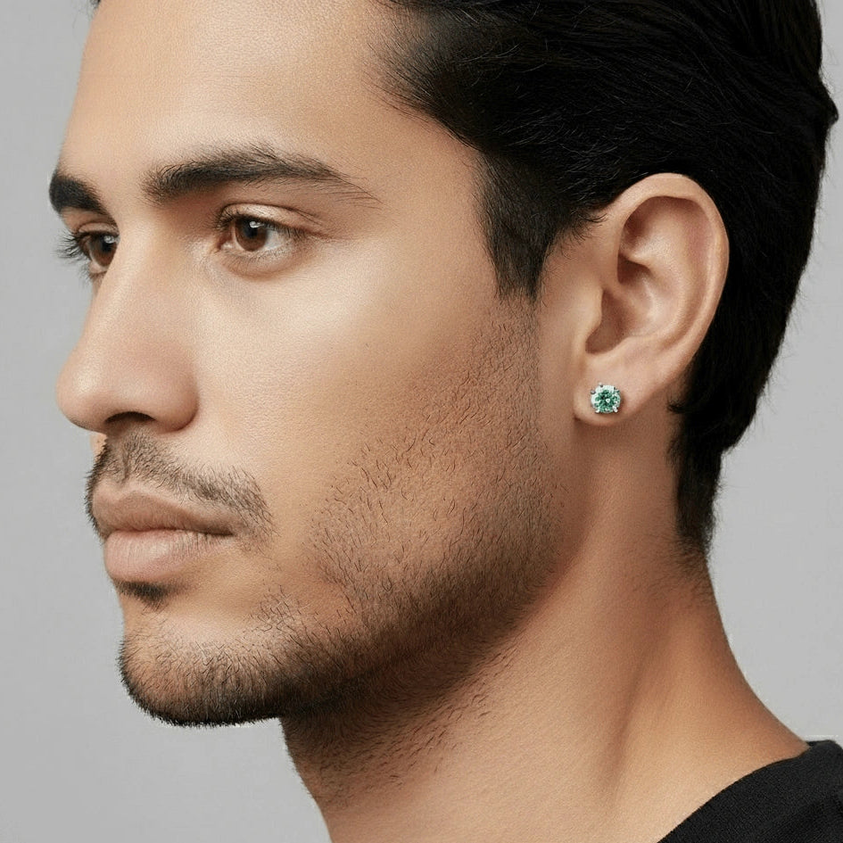 Close-up of a red moissanite stud earring worn on a man's ear, round cut, 4-prong setting - Sensitive Stones