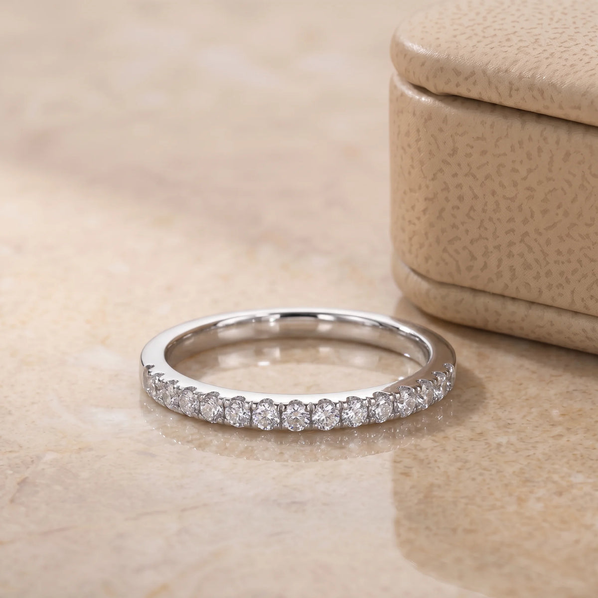 Angled view of the moissanite half eternity ring shown in both white gold and yellow gold finishes each sold separately - Sensitive Stones