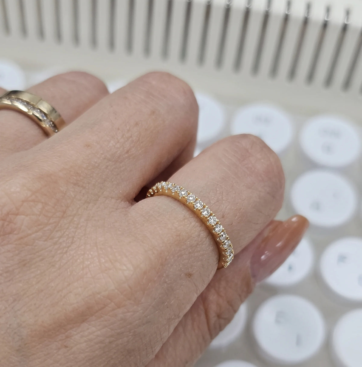 Hand wearing the moissanite half eternity ring in 925 sterling silver with a yellow gold finish - Sensitive Stones