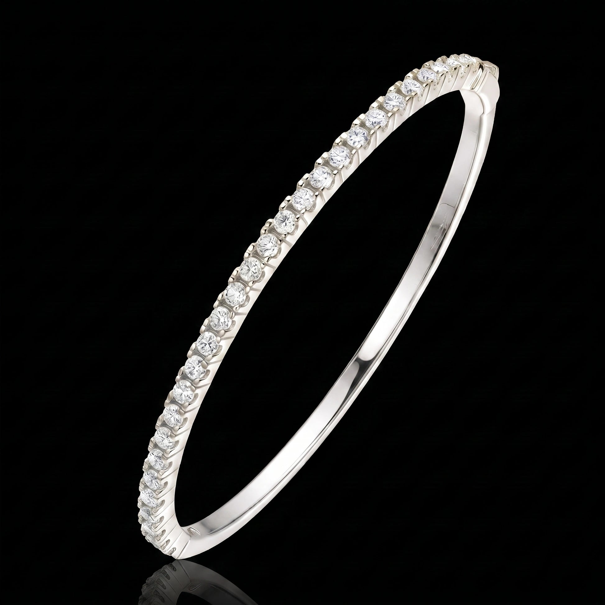 White gold moissanite half tennis bangle bracelet, 2.5mm round-cut stones in 925 sterling silver, on a black reflective surface - Sensitive Stones
