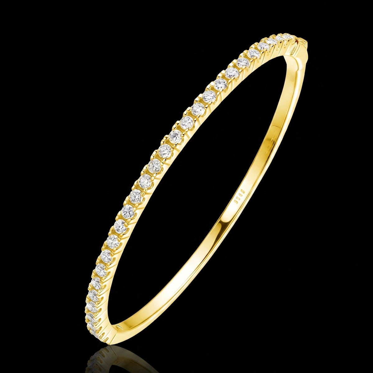Yellow gold moissanite half tennis bangle bracelet, 2.5mm round-cut stones in 925 sterling silver, on a black reflective surface - Sensitive Stones