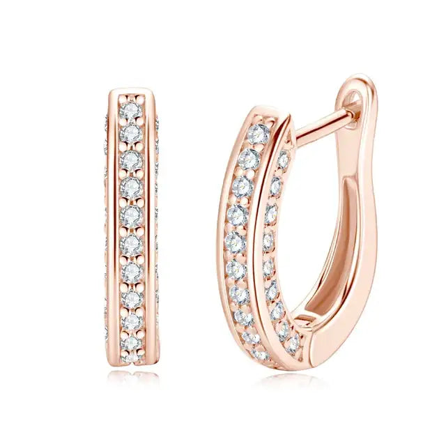 Moissanite huggie hoop earrings in 925 sterling silver with a rose gold finish showing the front face and side profile with pave rows of stones - Sensitive Stones