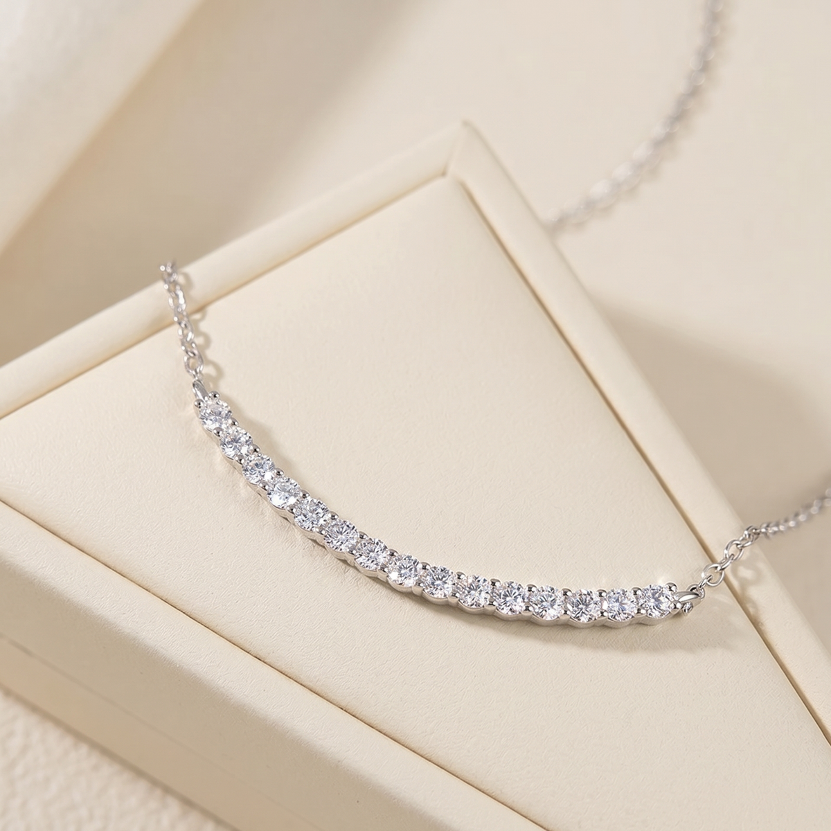 Moissanite smile bar necklace in 925 sterling silver with a white gold finish in a cream jewelry box - Sensitive Stones