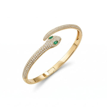 Moissanite snake bracelet set in 925 silver and 18k gold plating with lab-emerald eyes on a white background - Sensitive Stones