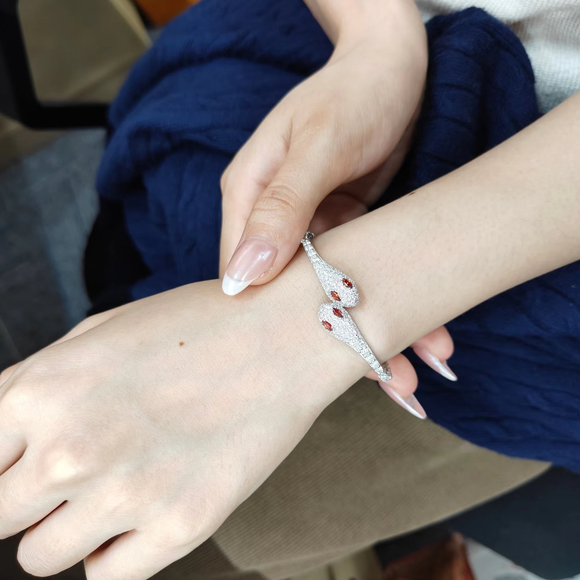 Model wearing silver double head moissanite snake bracelet with red cubic zirconia accents – Sensitive Stones