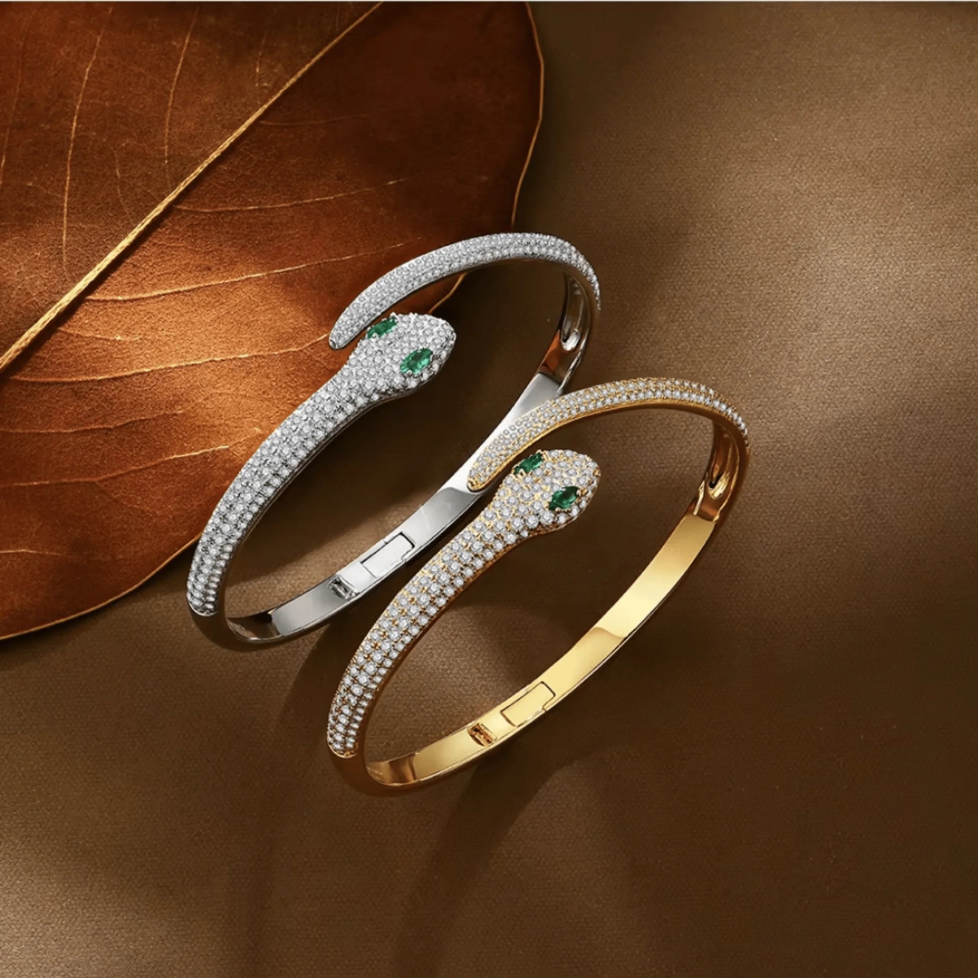Moissanite snake bracelets in yellow and white gold color with green gemstone eyes, elegant serpent design | Sensitive Stones
