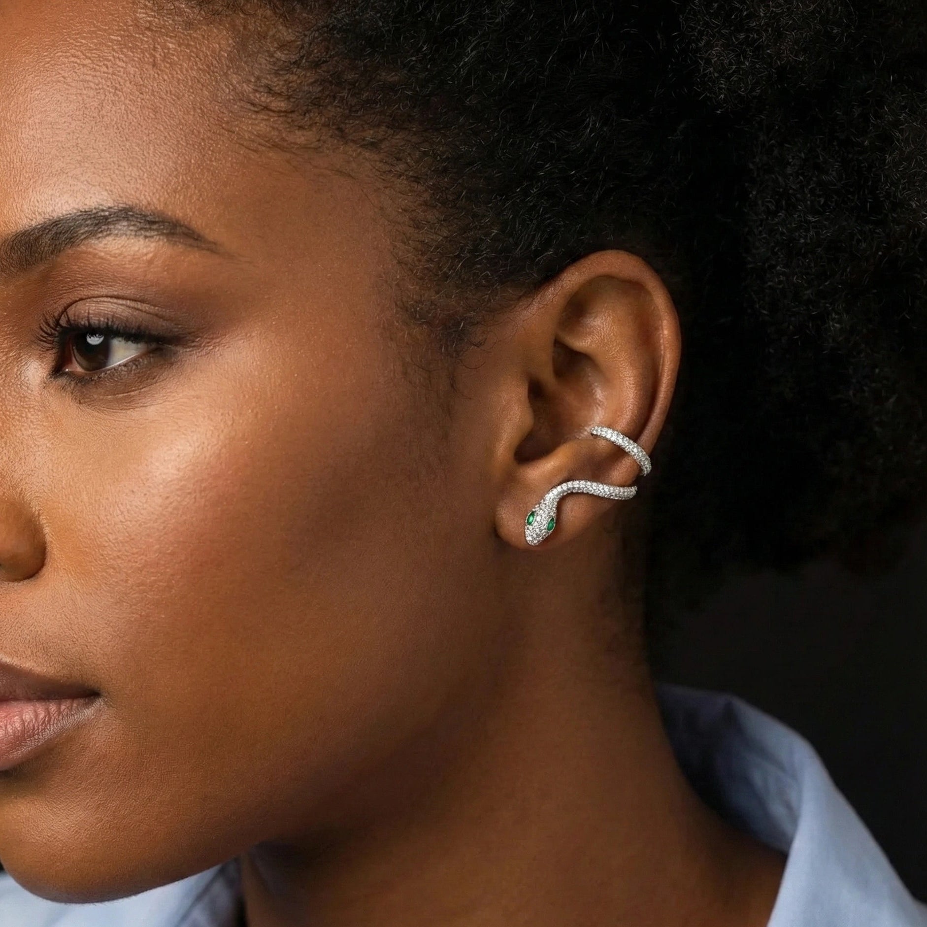 Elegant moissanite snake ear climber earring wrapping along the ear, crafted in 18K white gold over sterling silver, worn on a ear