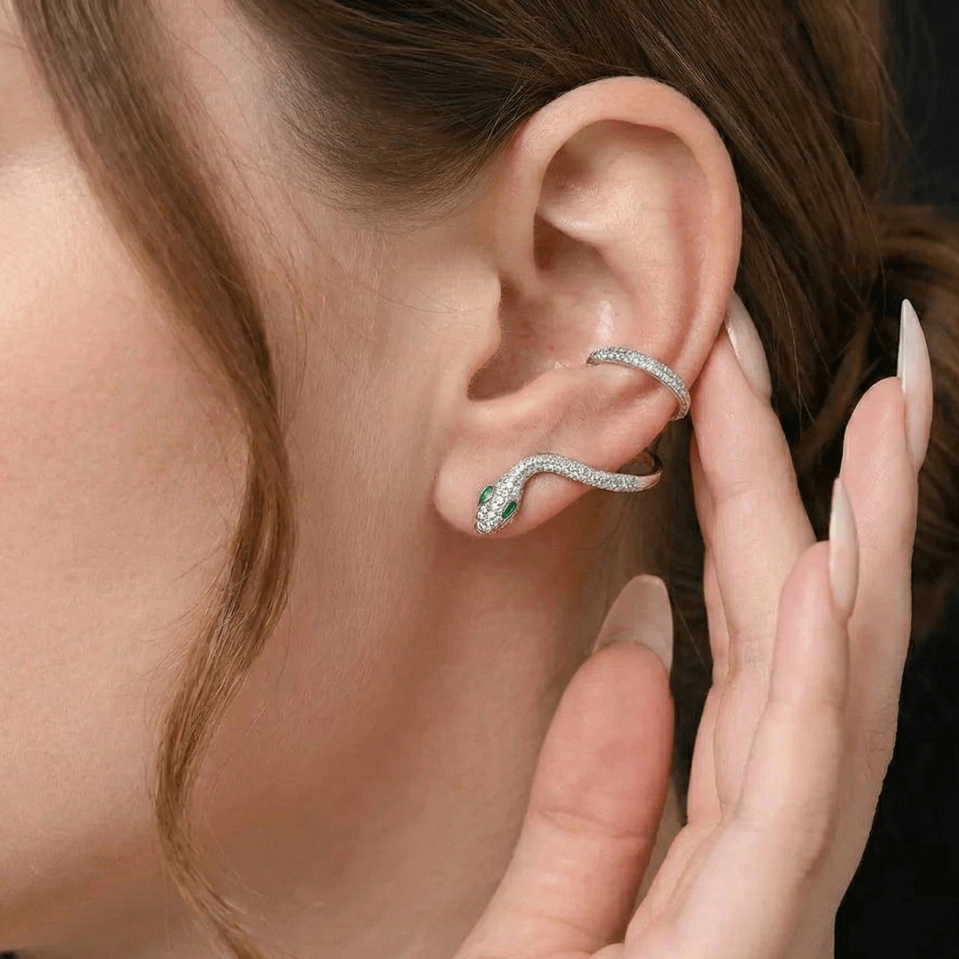 Sterling silver moissanite snake climber earrings with round white moissanite stones and green accent details wrapping around the ear, showcasing diamond-like brilliance and serpent design - Sensitive Stones