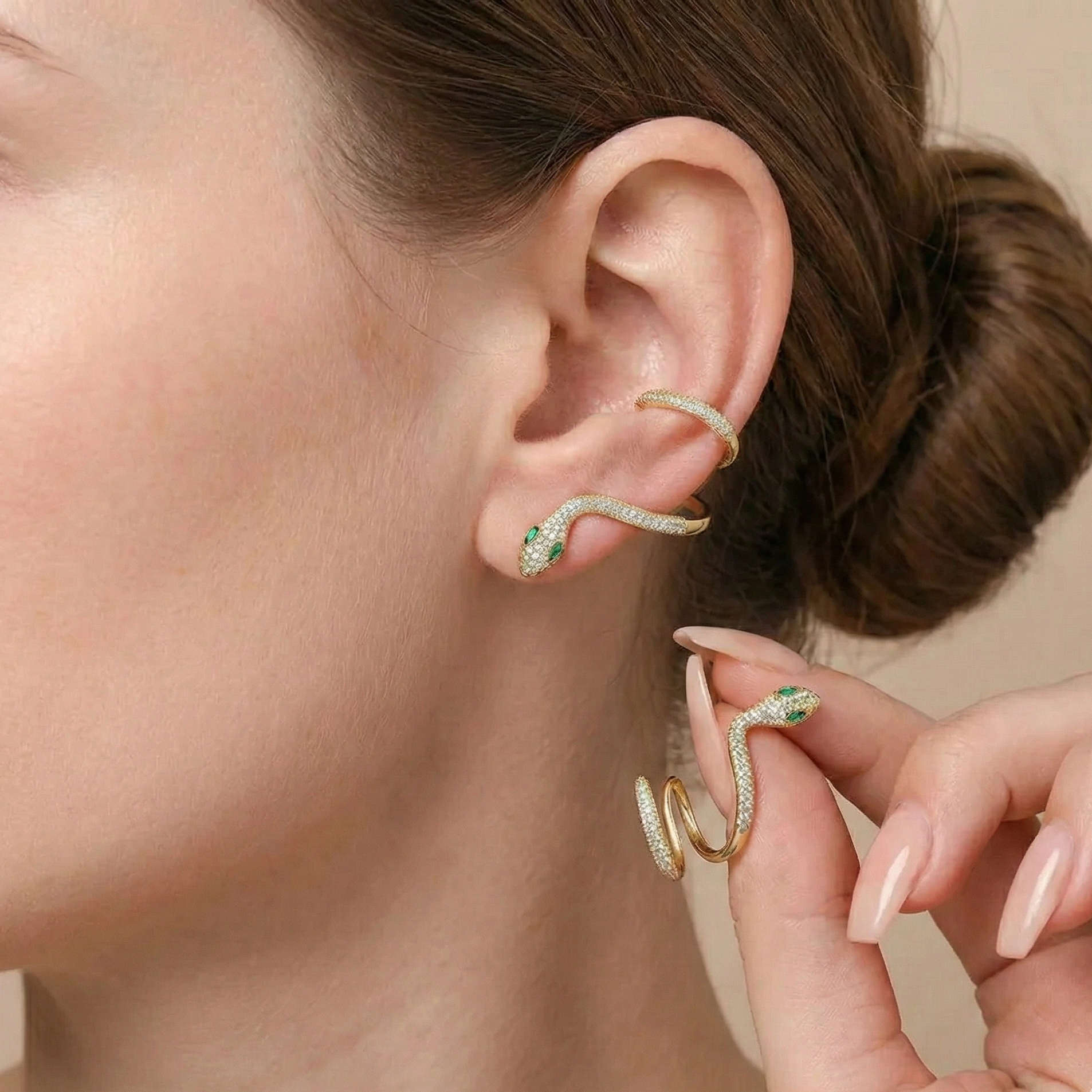 Close-up view of moissanite snake climber earrings with marquise-cut green nano gemstones and white moissanite sparkle, displaying refined sculptural detail on earlobe - Sensitive Stones