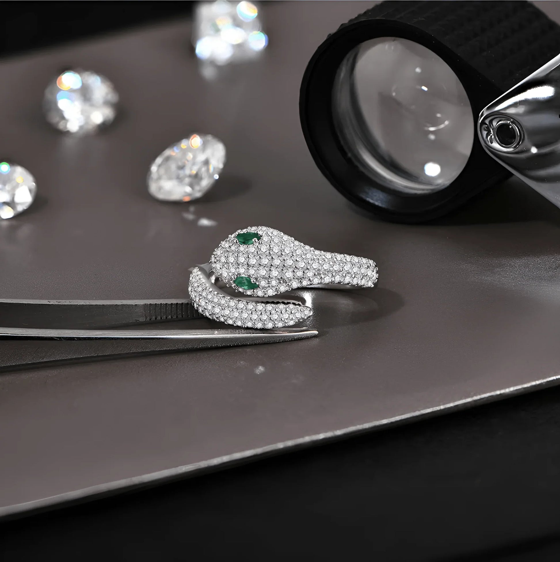 Silver moissanite snake ring with green gemstone eyes, close-up lab inspection view | Sensitive Stones