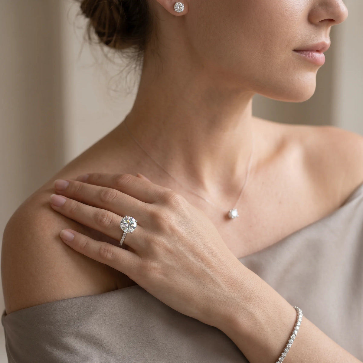 Model wearing the moissanite solitaire engagement ring with its 5A cubic zirconia pave band styled alongside moissanite studs a pendant necklace and a tennis bracelet sold separately - Sensitive Stones