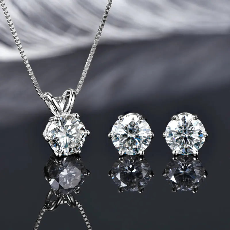 Studio shot of silver moissanite solitaire necklace and matching stud earrings in white gold finish, showcasing the radiant sparkle of each stone - Sensitive Stones