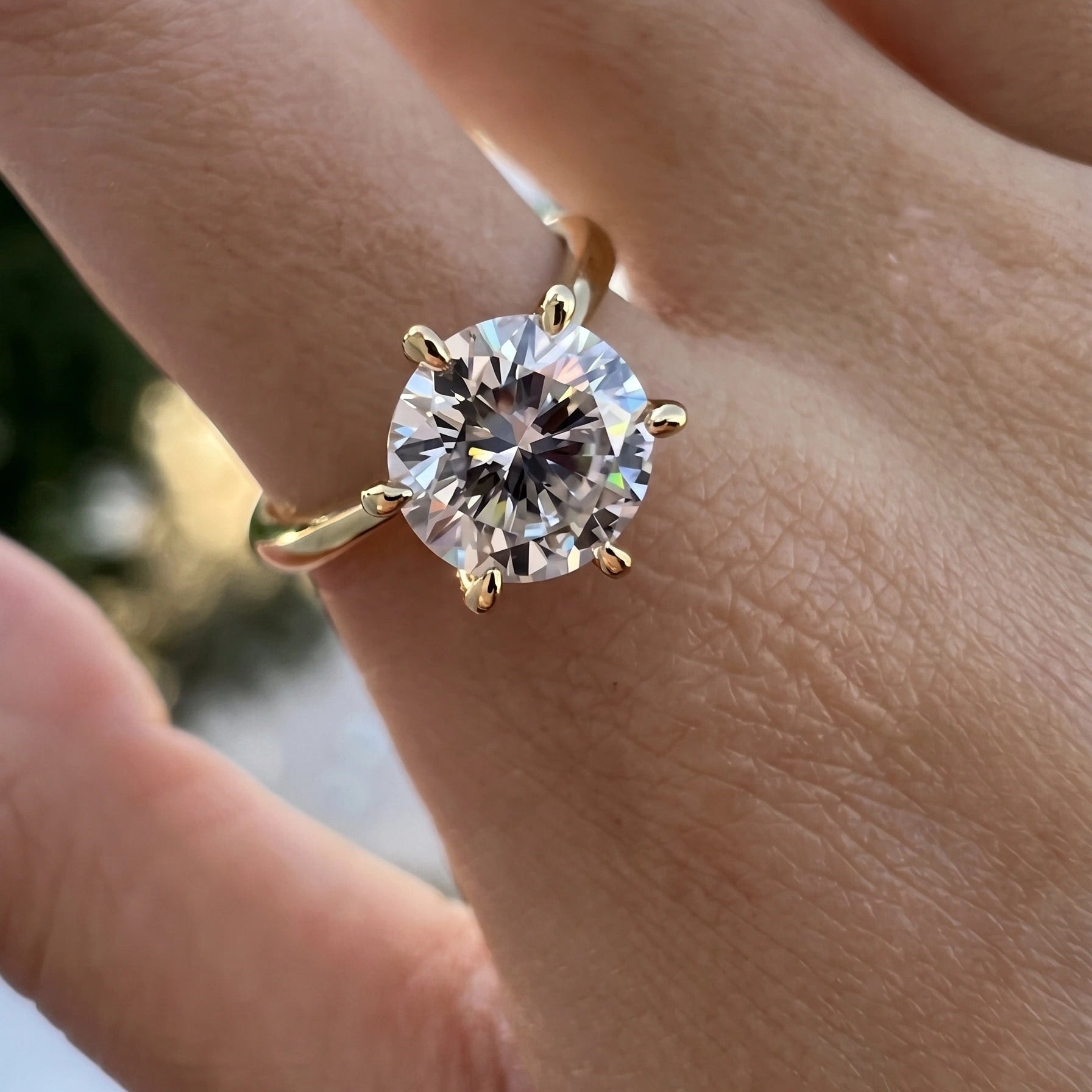 14K gold filled moissanite solitaire ring photographed in natural light showing stone fire and brilliance - Sensitive Stones