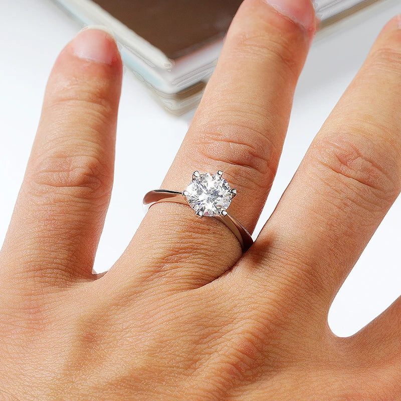 Classic silver moissanite engagement ring shown worn on finger with brilliant sparkle - Sensitive Stones
