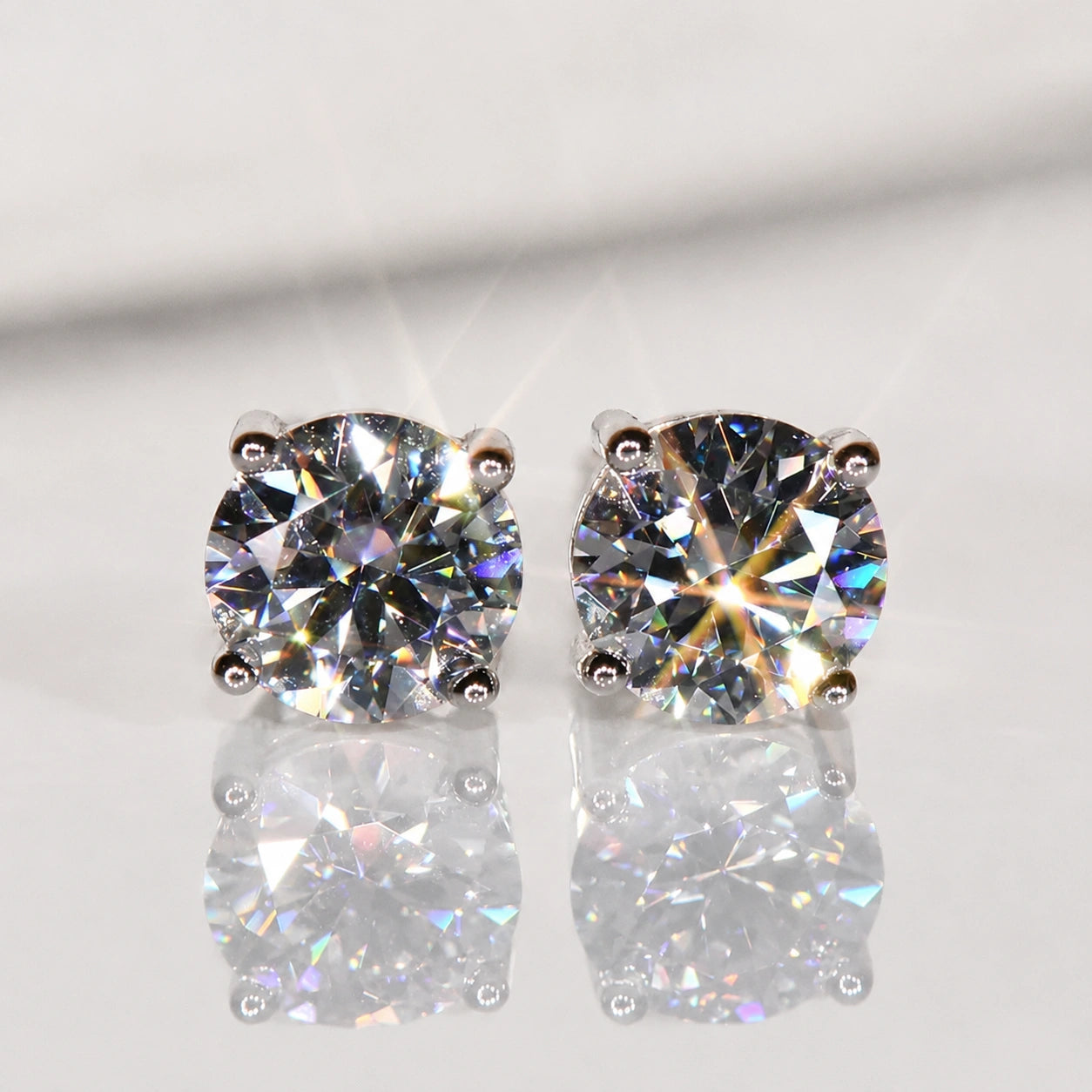 Front view of a pair of 4-prong moissanite solitaire stud earring in 925 sterling silver showing butterfly back closure – Sensitive Stones