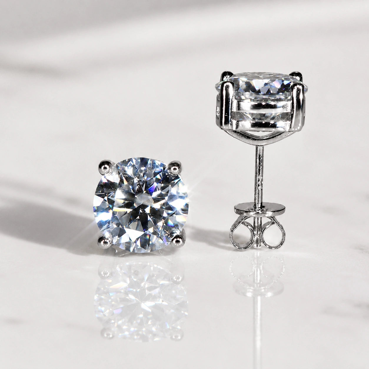 Front and side view of 4-prong moissanite solitaire stud earring in 925 sterling silver showing butterfly back closure – Sensitive Stones