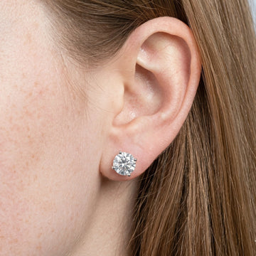 Close up of model wearing 4-prong moissanite stud earrings in 925 sterling silver – Sensitive Stones
