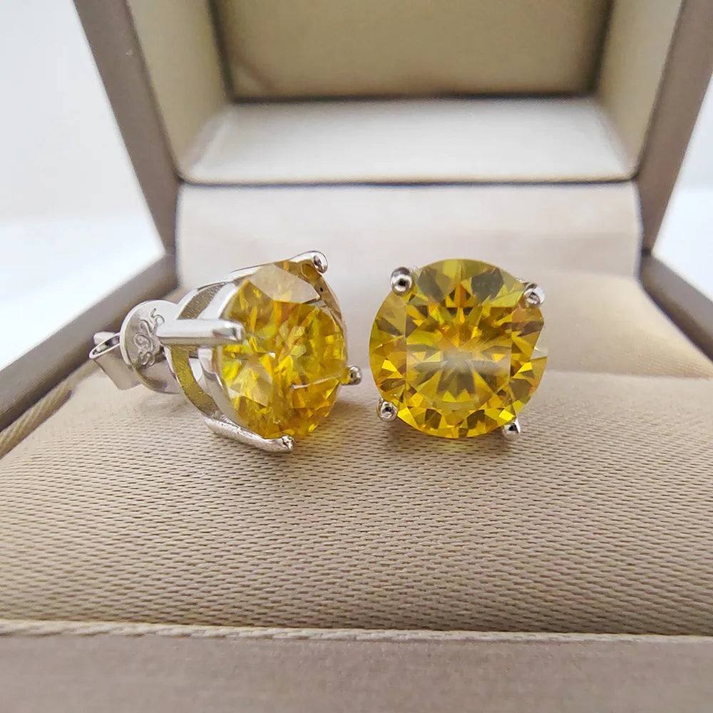 Pair of yellow moissanite stud earrings, round cut, set in 925 sterling silver with buttery back placed in a jewelry box | Sensitive Stones