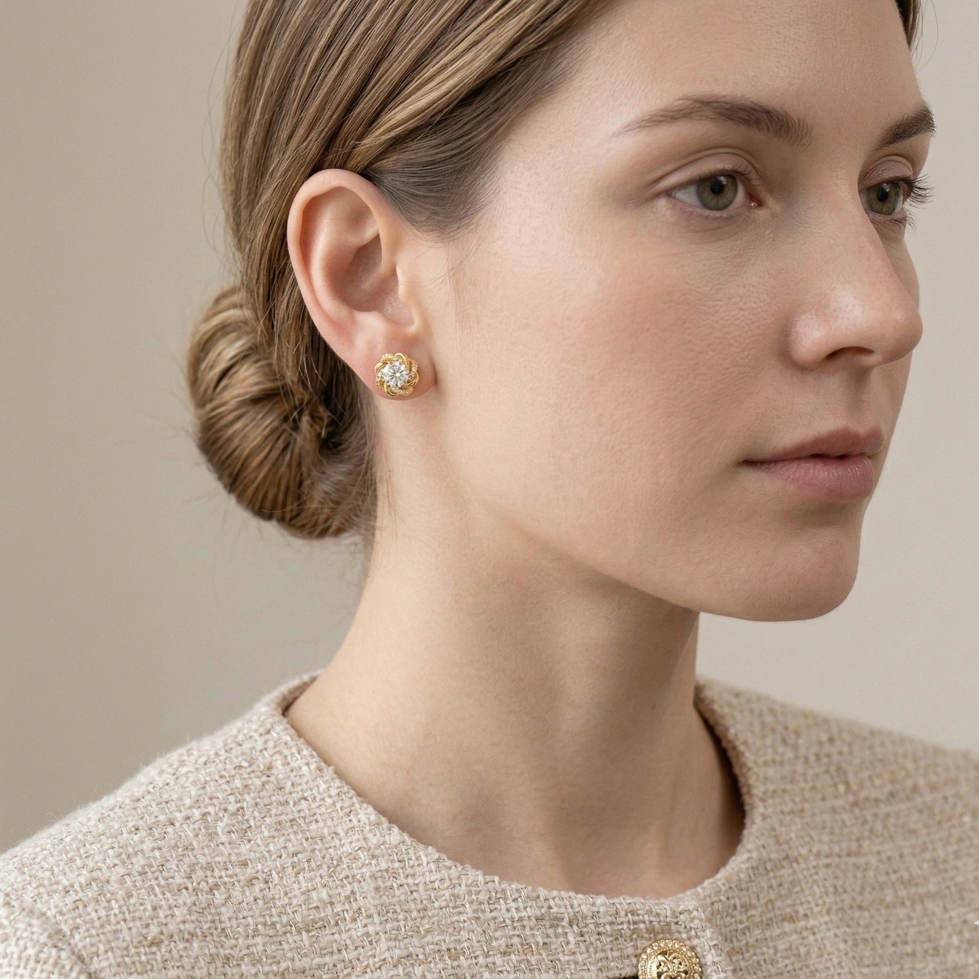 Woman wearing 1ct moissanite swirl flower stud earring in 18K gold plated 925 sterling silver styled with bouclé tweed jacket - Sensitive Stones