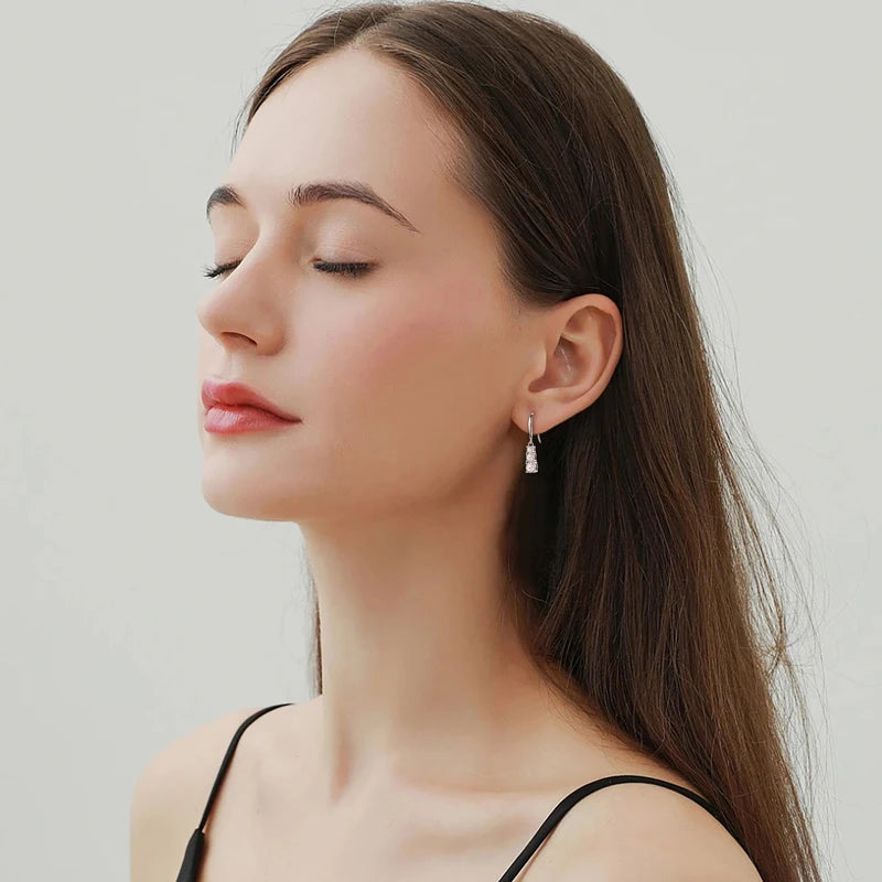 Moissanite three-stone dangle earrings in silver worn by model, side profile - Sensitive Stones