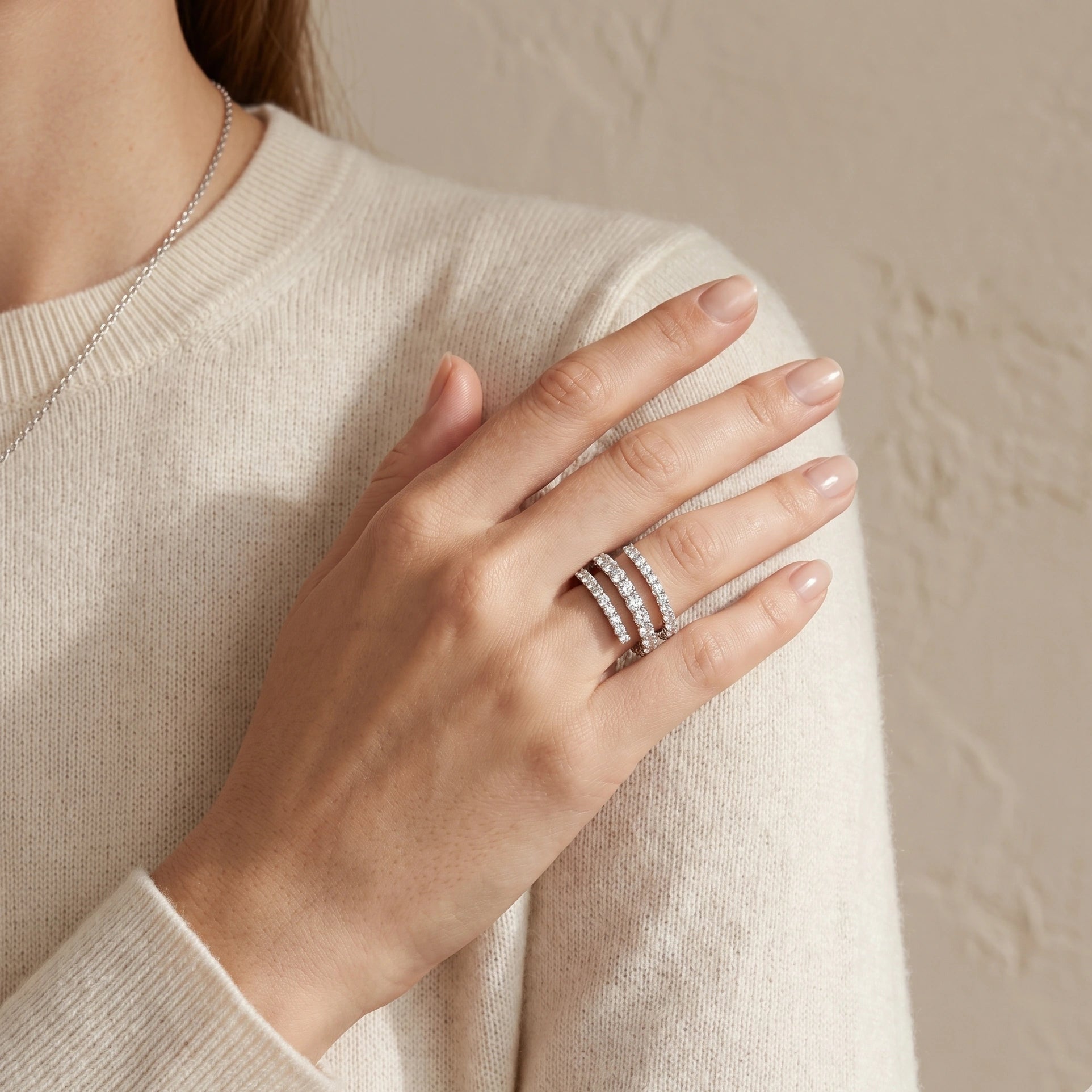 Moissanite triple wrap spiral ring in silver tone worn on hand with knit sweater - Sensitive Stones